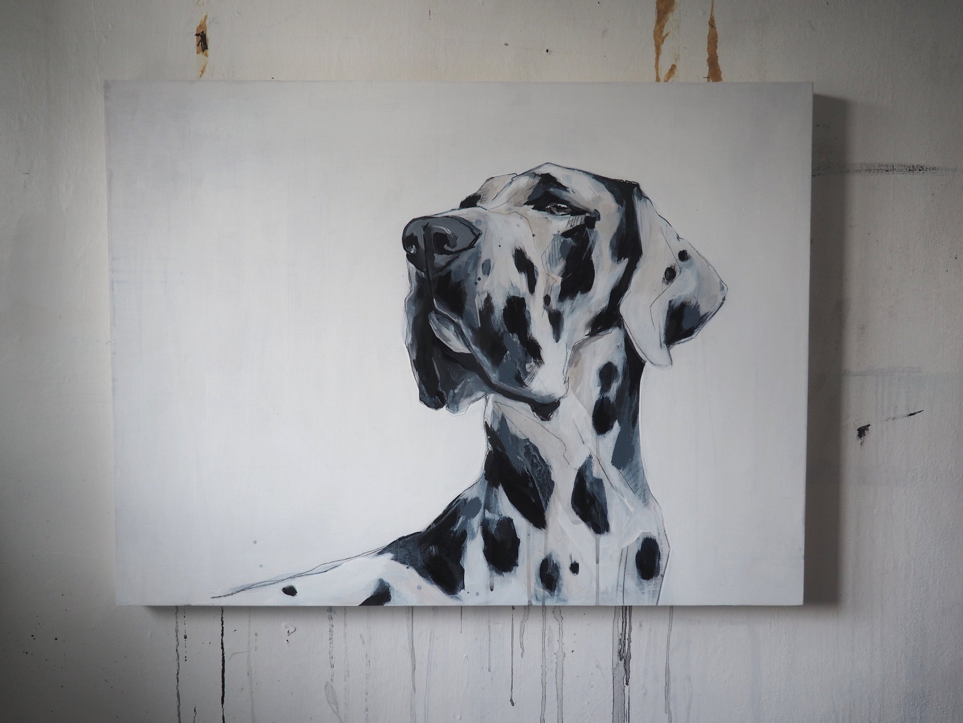 Dog portrait painting of a spotty great dane on a wood panel, hung on a textured wall.